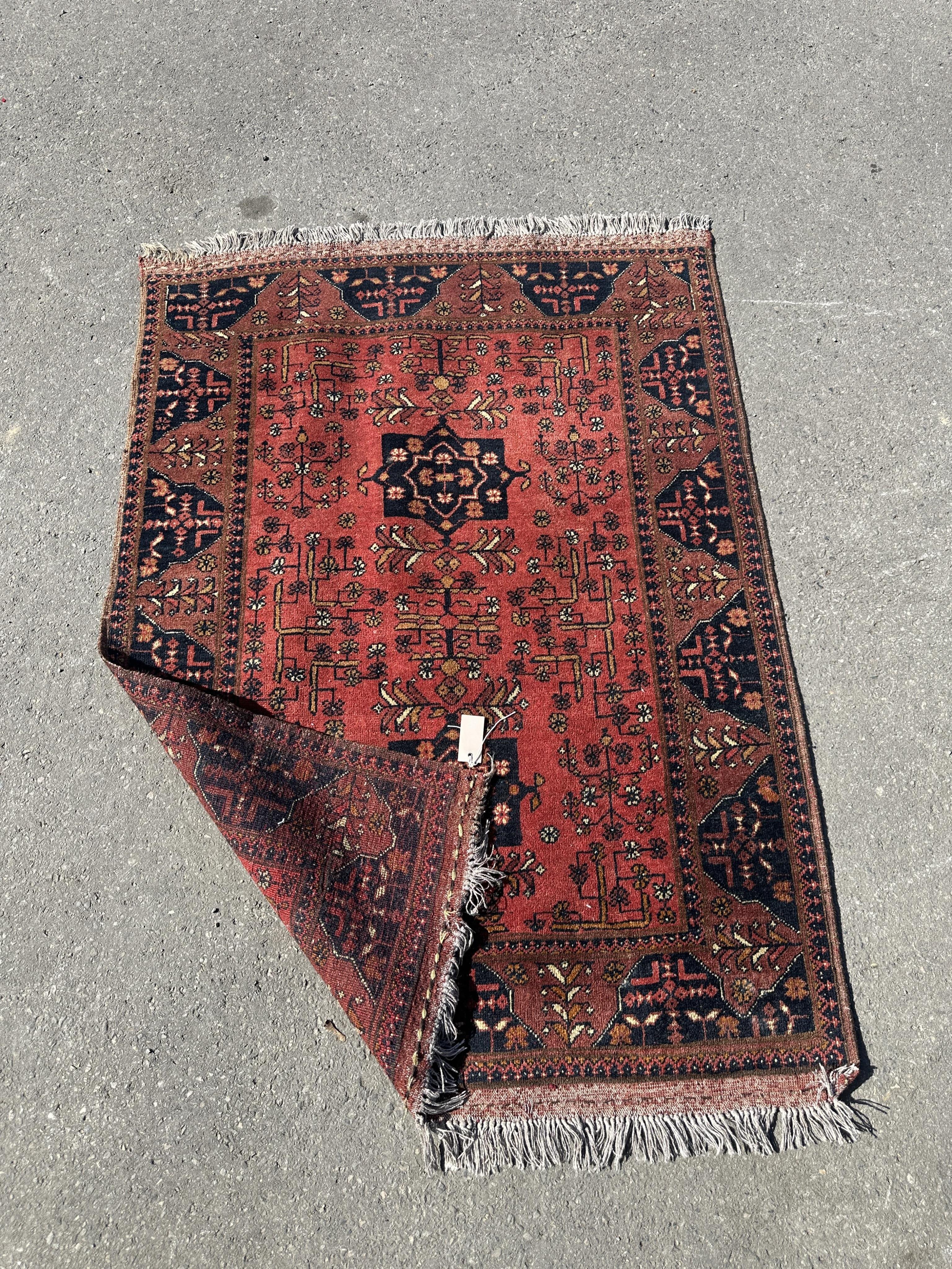 A Belouch red ground rug, 140 x 108cm